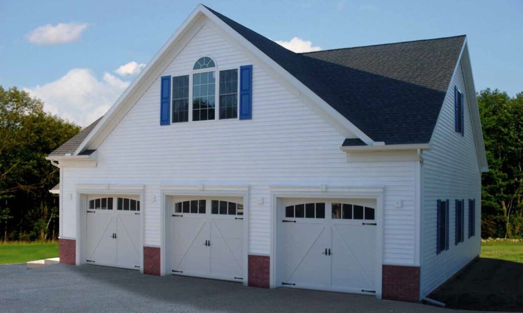 An image of a white garage with three bays.
